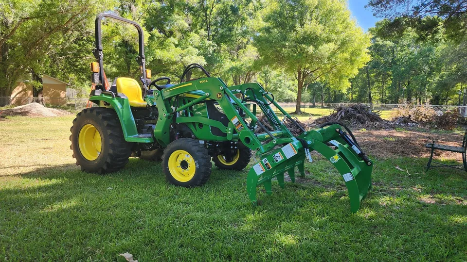 Tractor and grapple ready for brush removal and hauling